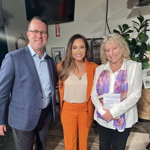 Three guests, one in orange blazer